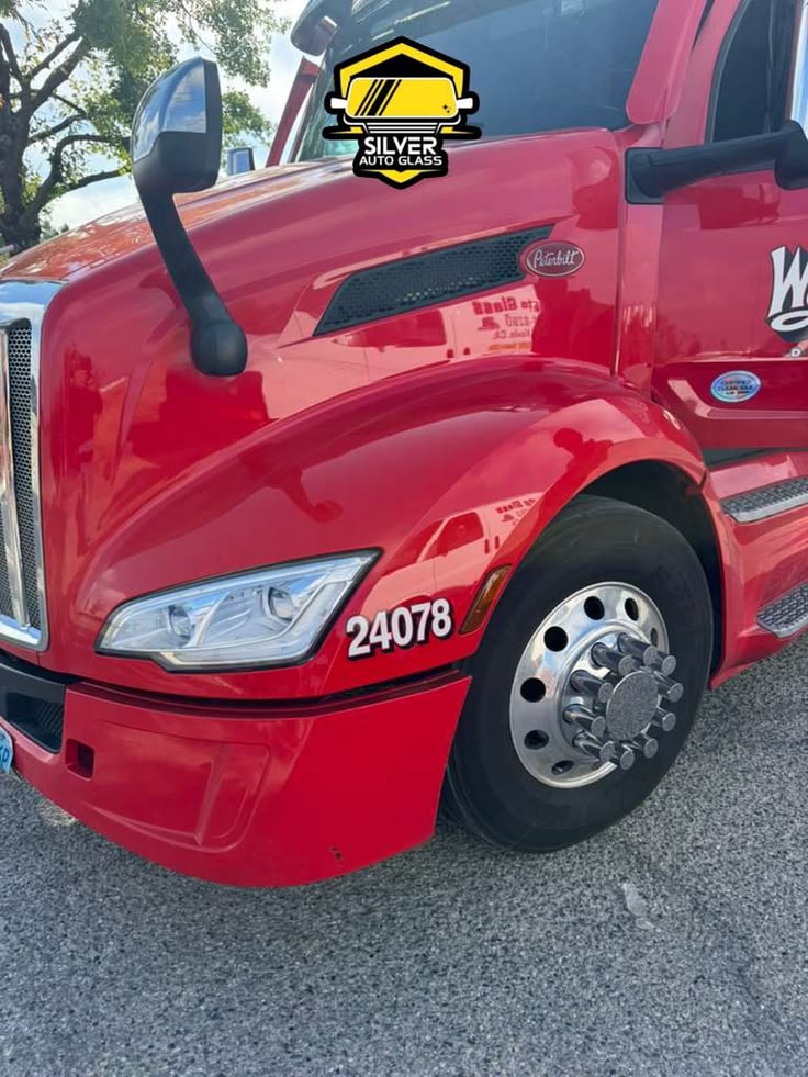 Red Peterbilt commercial truck with Silver Auto Glass logo overlay